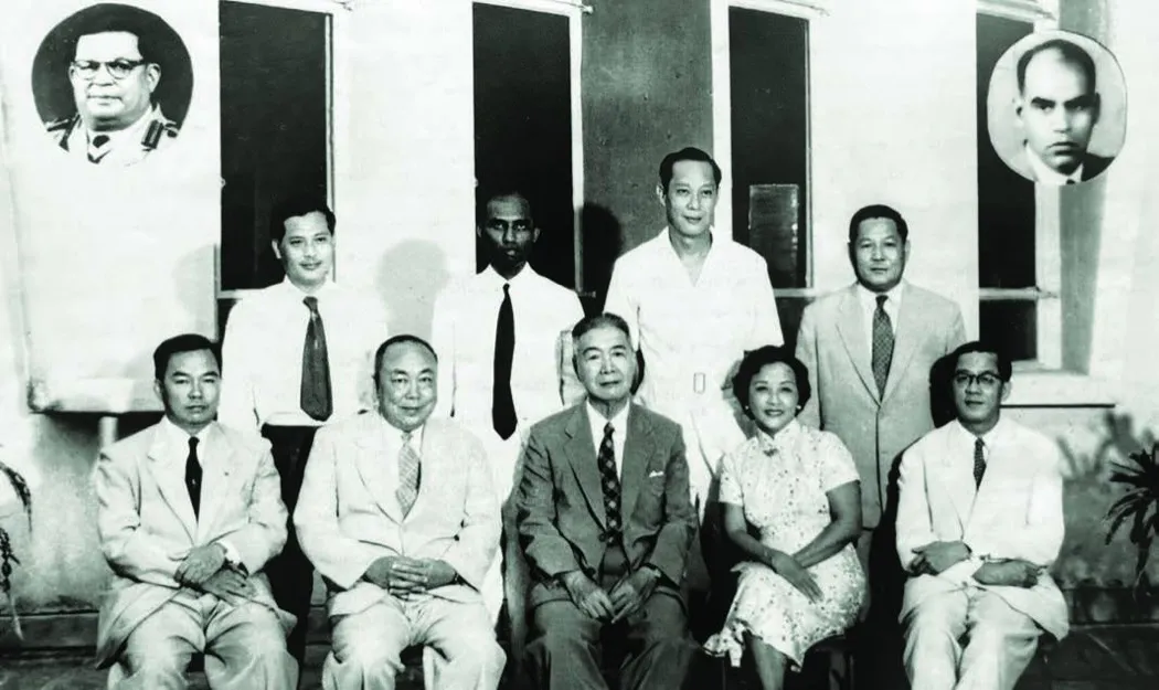 Black and white portrait of the Alumni Association Building Committee with inset portraits of two members who died before completion
