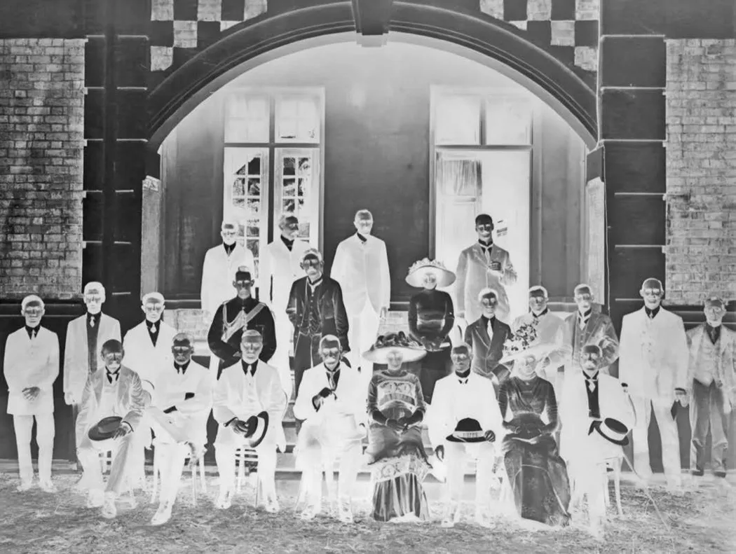 Formal group beneath the arched entrance of the Tan Teck Guan Building at its opening