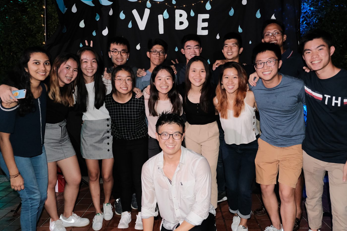 Students gathered in front of the VIBE backdrop